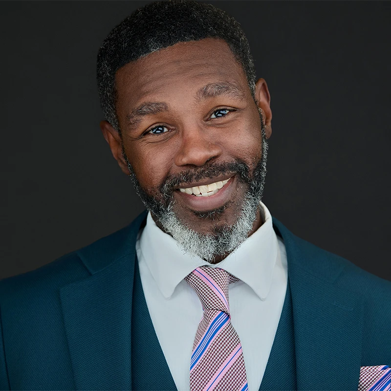 Exeter business headshots — confident, approachable portraits on a dark studio background.