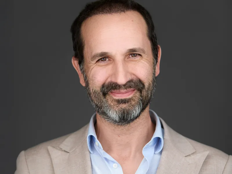 Falmouth Executive Headshots | Mature Professional Portrait Photography Mature professional with full beard in light grey blazer and blue shirt, confident smile
