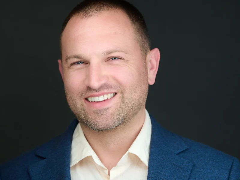 Relaxed headshot of London executive showing authentic expression and approachability