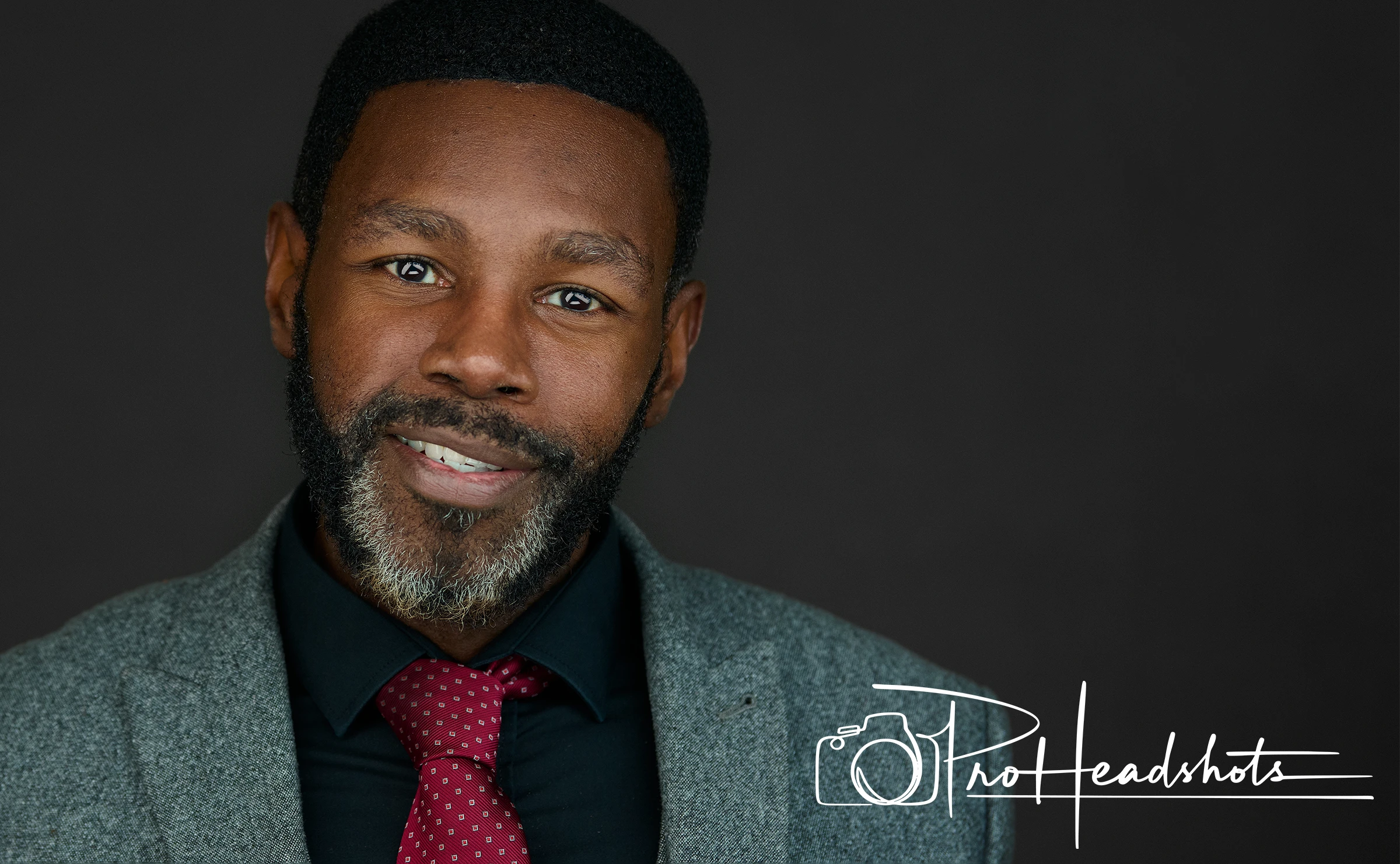 Plymouth business professional showcasing authentic confidence in his workplace headshot, his signature expression transforming his professional presence