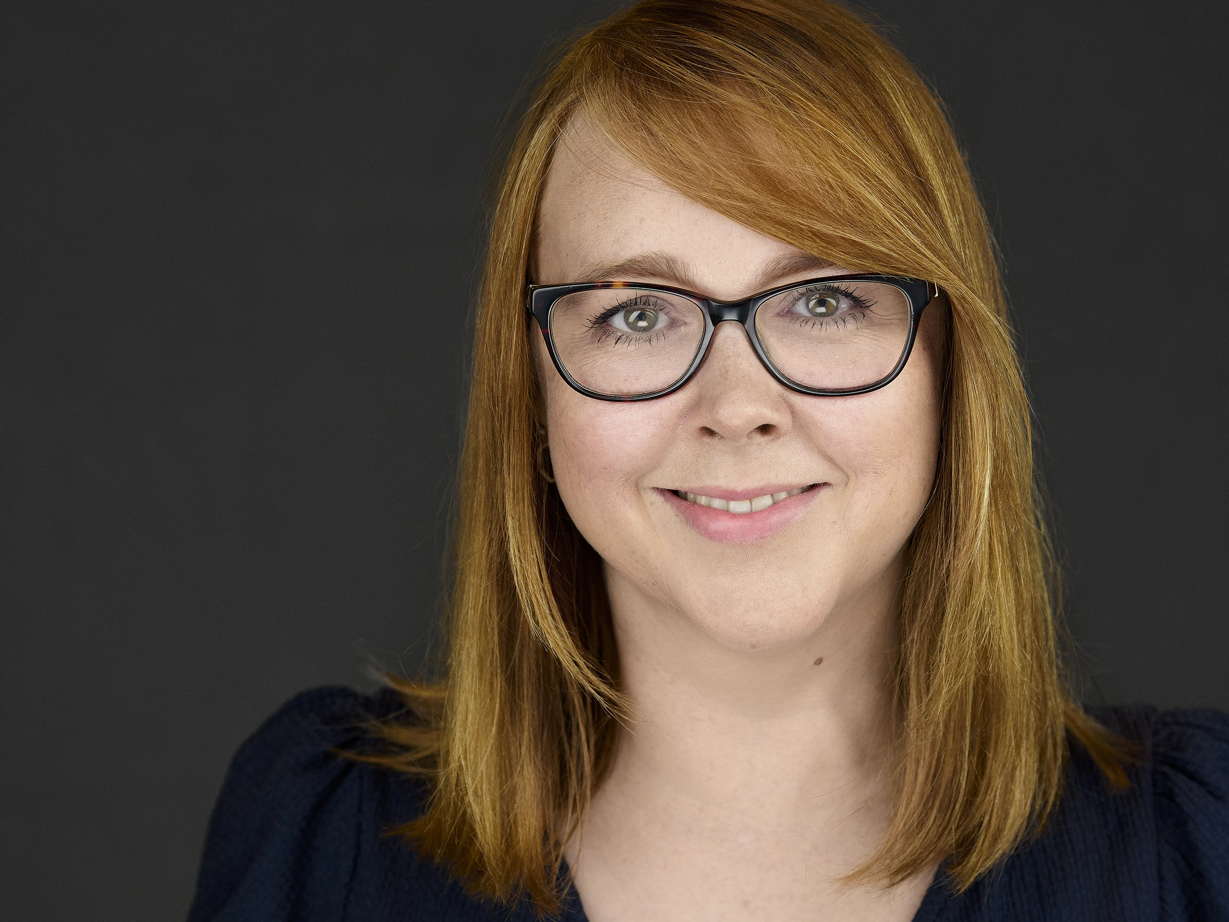 Plymouth businesswoman radiating authentic confidence during her mobile headshot session, her expression perfectly blending warmth with executive presence