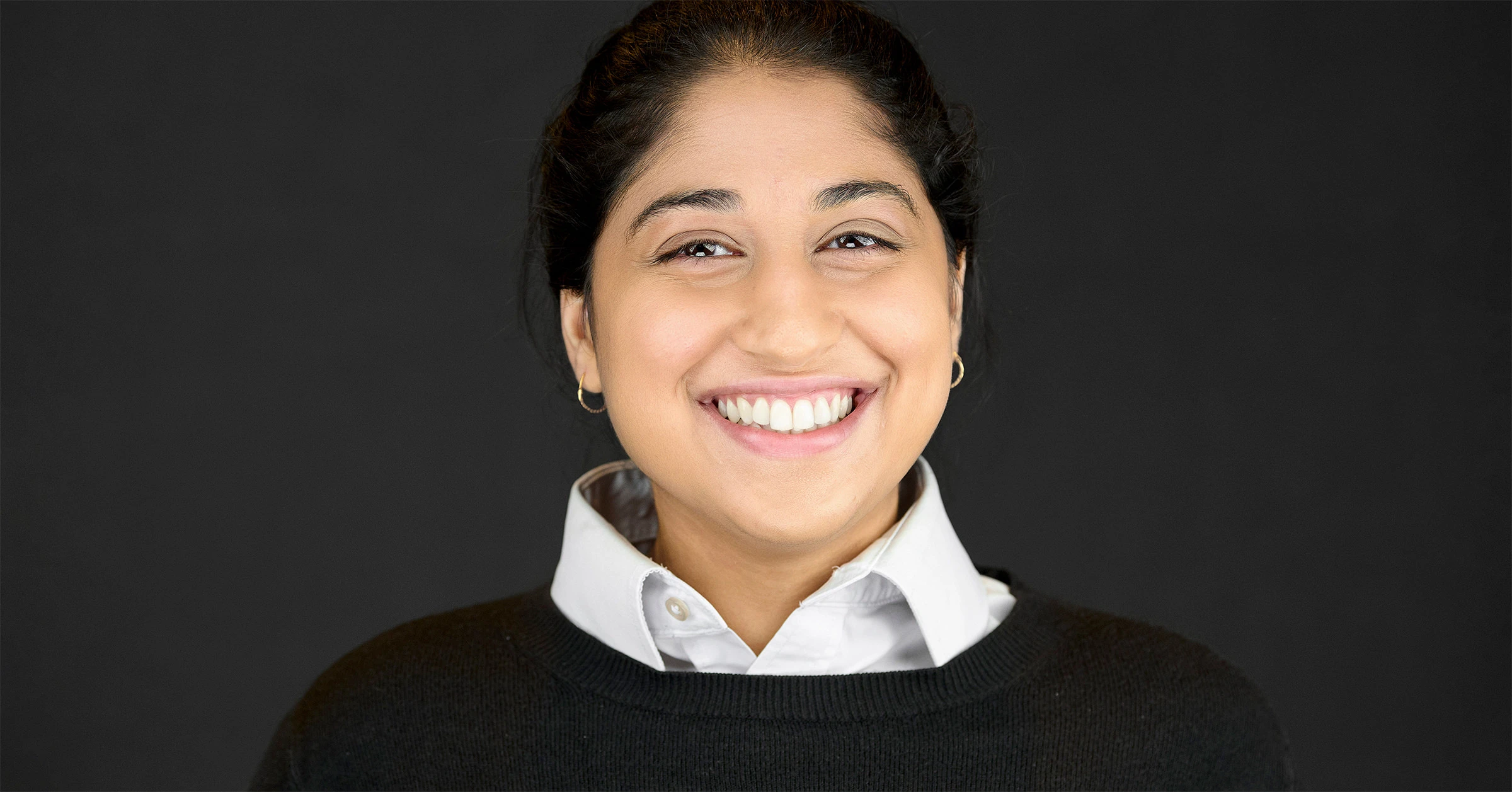 Three professional headshots against dark backgrounds showcasing business professionals - a distinguished man in a blue blazer and white shirt, a stylish woman in a sage green blouse, and a confident man in a dark suit with blue tie. Pro Headshots logo overlaid in gold.