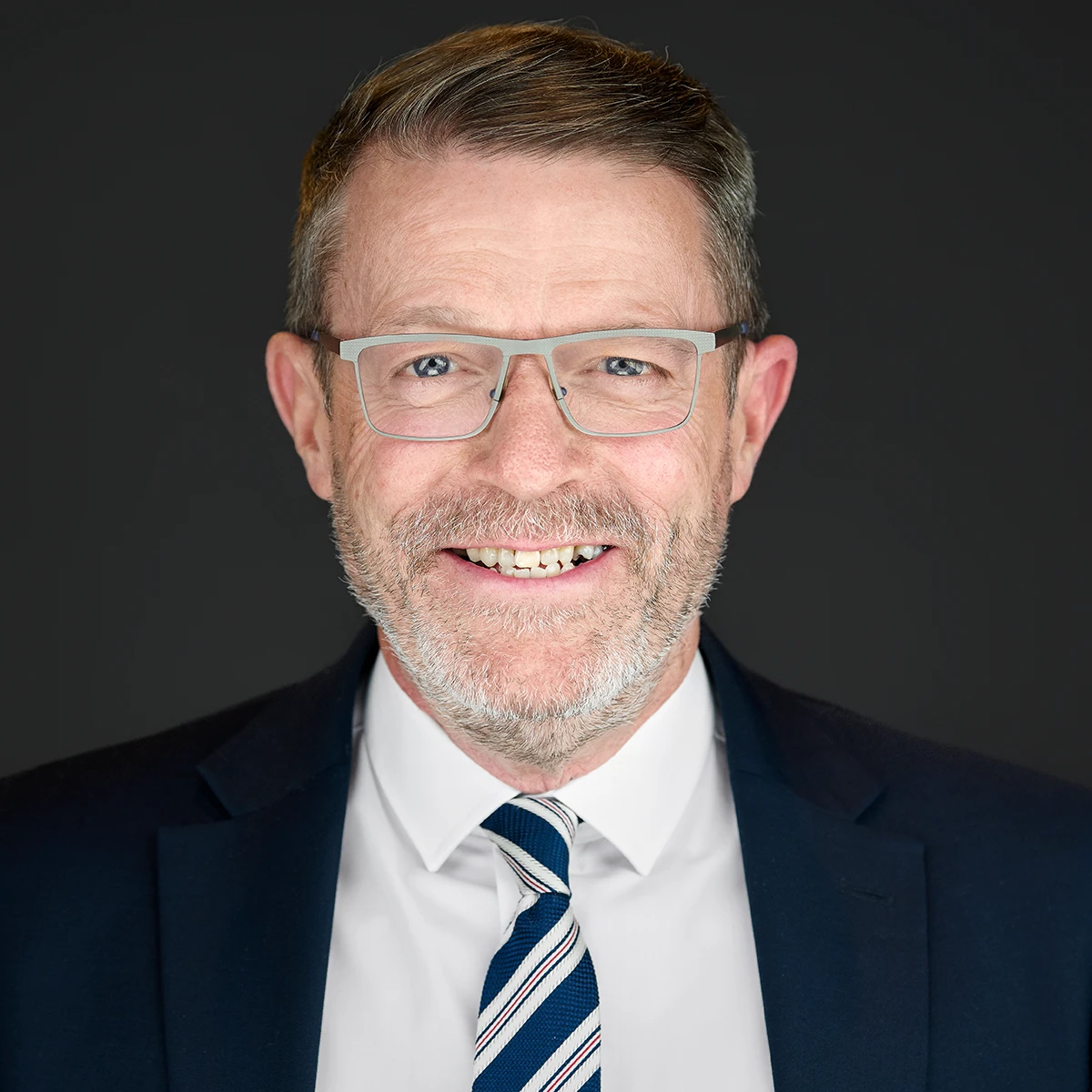 Onsite business photography of a business man wearing glasses and a beard