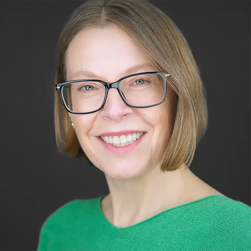 Business professional holding outdated headshot photo next to current appearance, demonstrating obvious need for professional headshot update