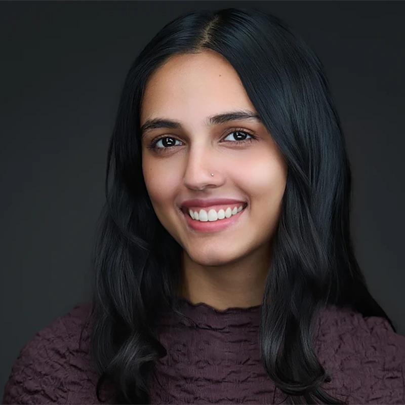 A professional reviewing headshot images on a laptop during a session