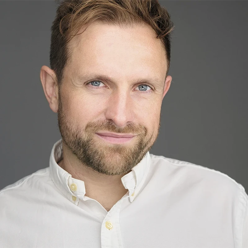 Business team receiving professional headshots in modern office environment, demonstrating coordinated corporate photography process