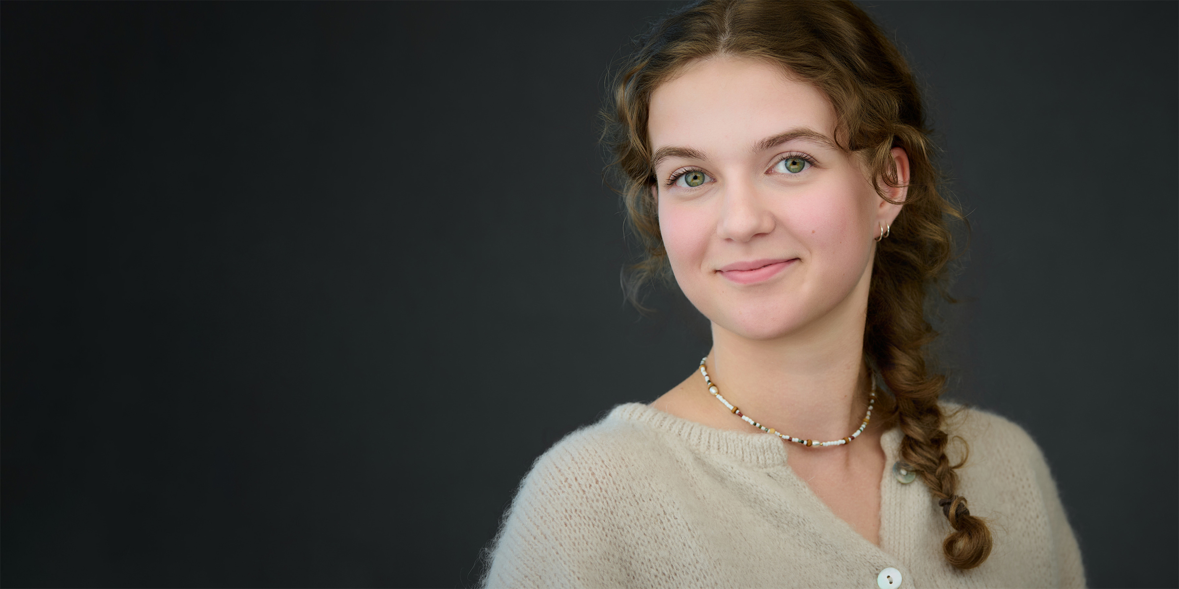 Relaxed on-location headshot session in an office space Professional photographer guiding a relaxed business professional during an on-location headshot session in an office