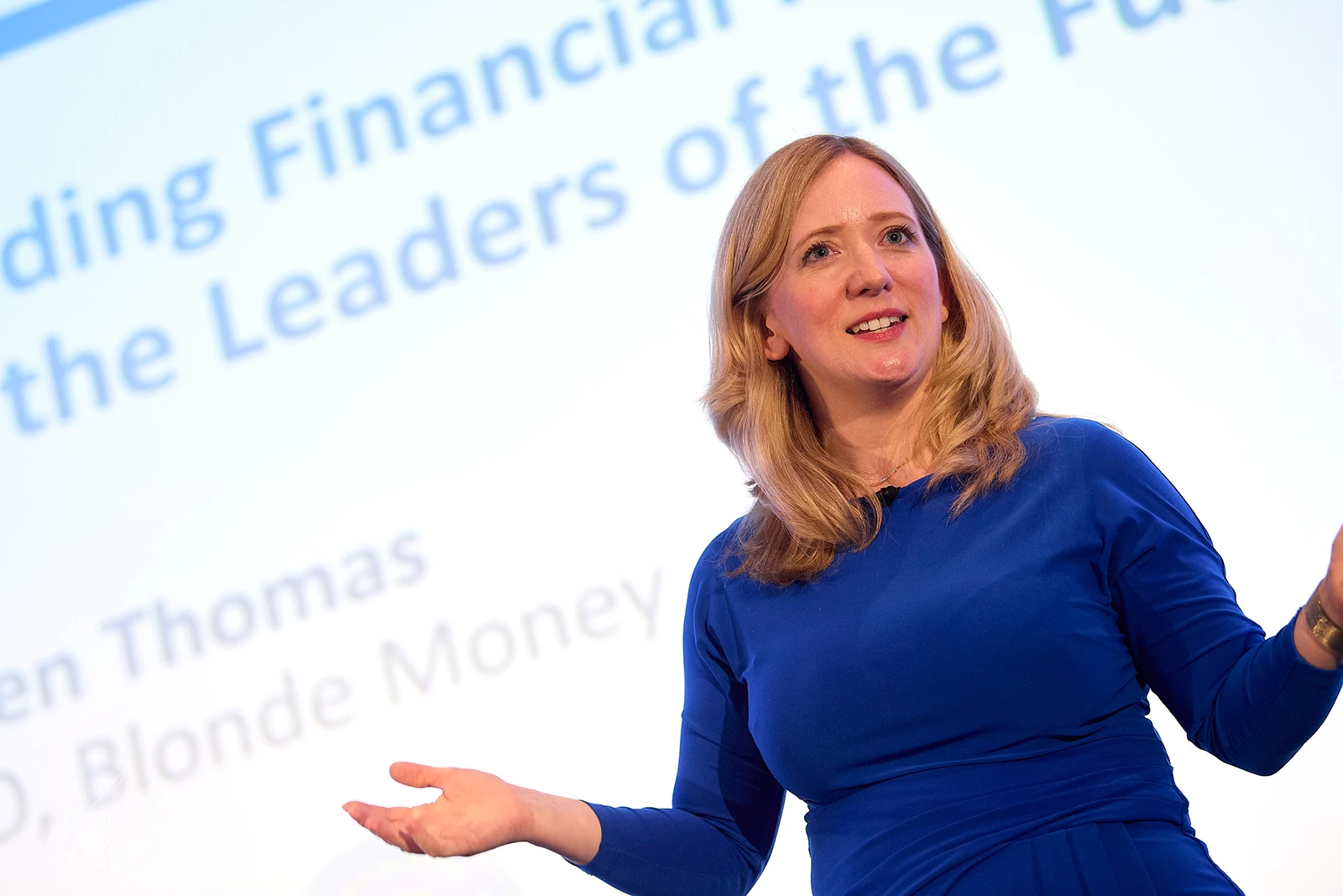 Helen Thomas close-up on stage, smiling mid-sentence, one hand extended