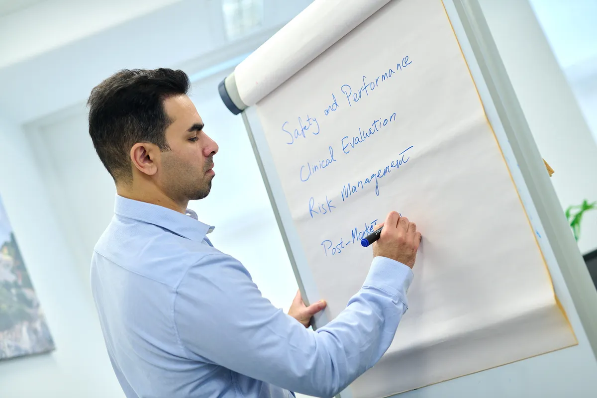 Consultant writing key points on a flip chart during a personal branding session