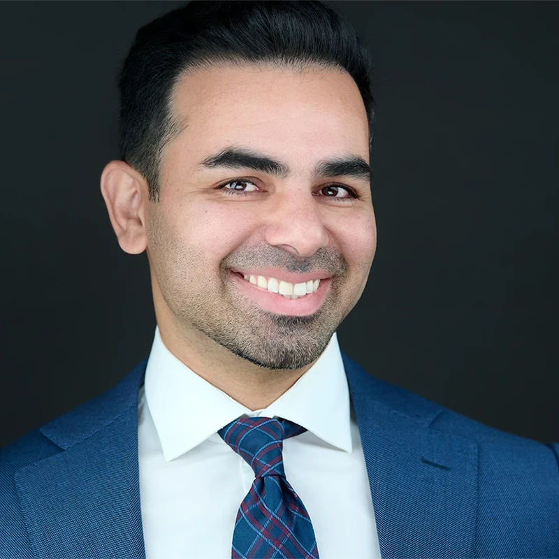 South West professional during a personal branding photo session, smiling confidently at their laptop