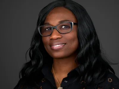 Business professional headshot with clean, modern styling against dark background