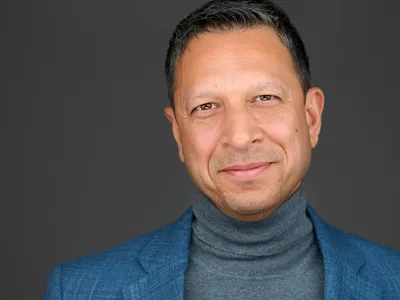 Business headshot with confident, approachable expression in studio setting