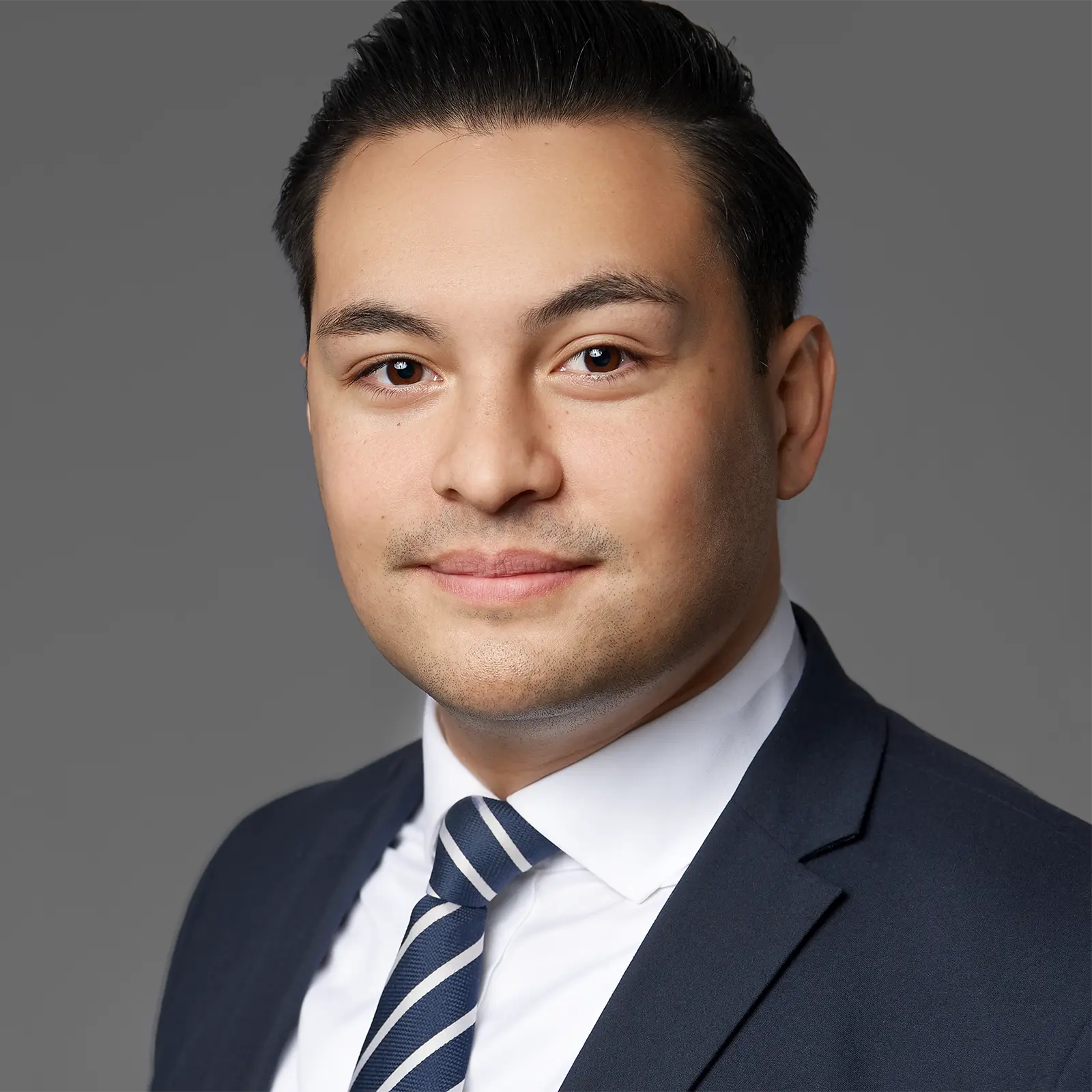 Corporate headshot of a man in a suit, captured on-site for a professional corporate portrait.