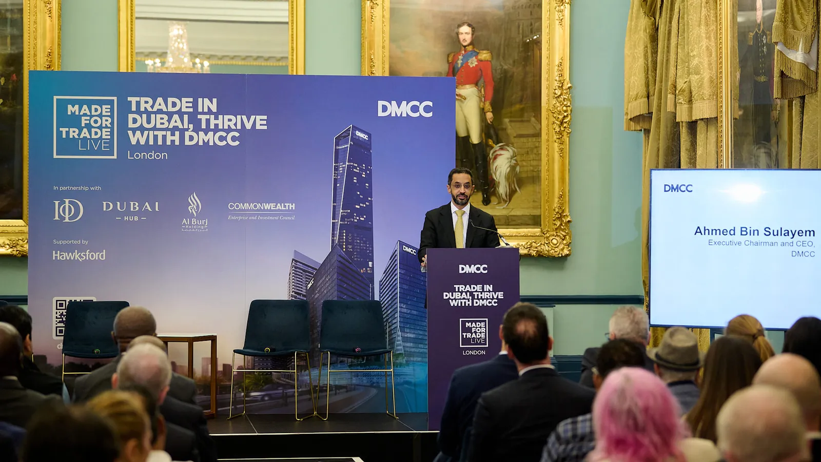 Ahmed Bin Sulayem, DMCC's Executive Chairman and CEO, speaking at a lectern in a gilt-framed room at 116 Pall Mall, in front of a Made for Trade Live London backdrop