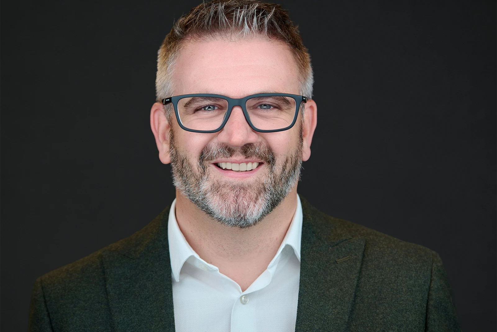 Professional portrait of person wearing glasses with reflections carefully eliminated
