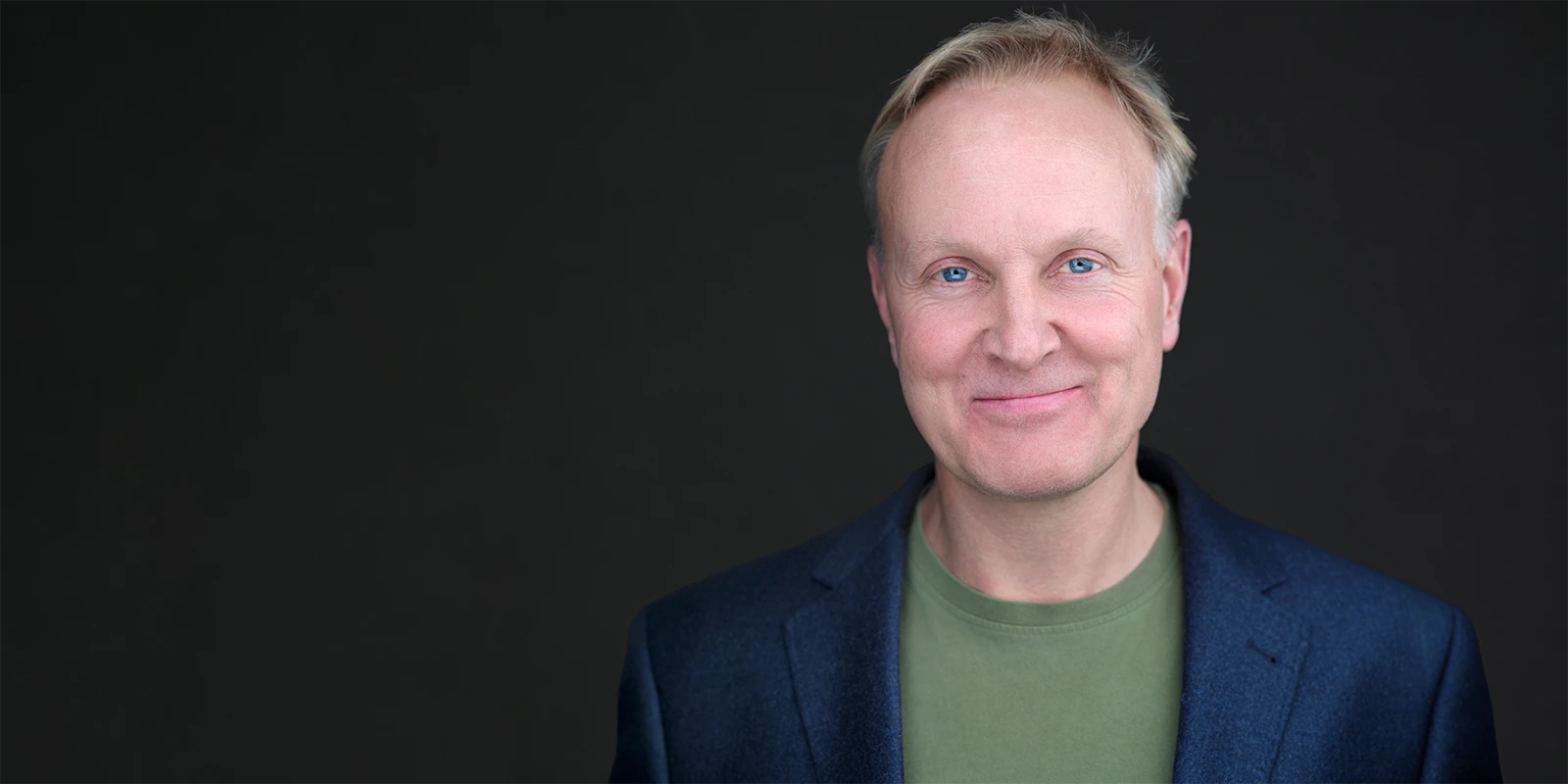 Photographer using expression and posture coaching during a professional headshot session