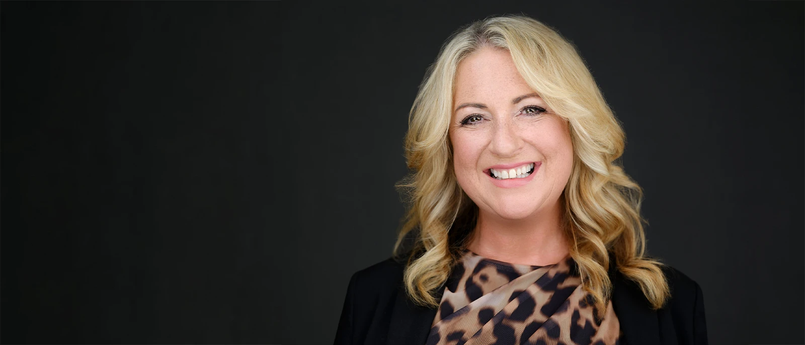 A professional business headshot session set up on location, the photographer reviewing images with the client