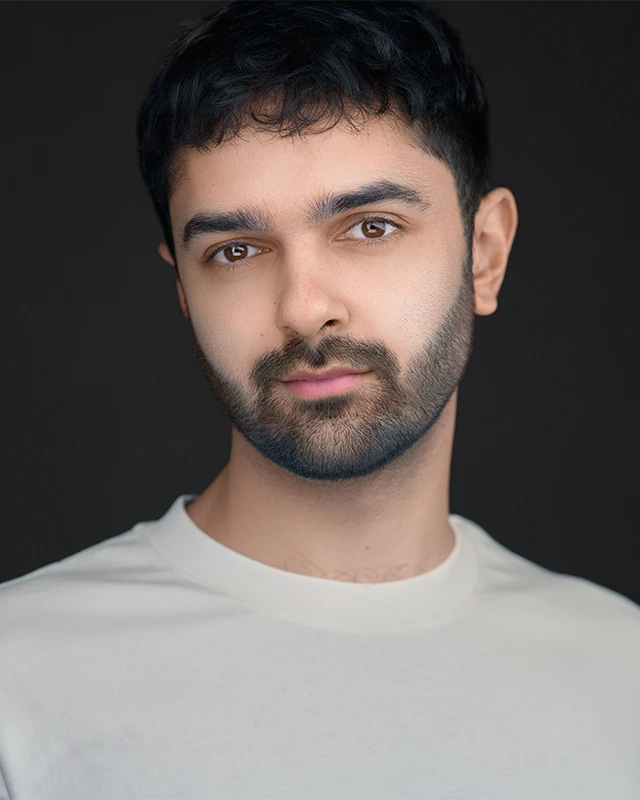 Professionally retouched headshot showing natural skin tone with blemishes gently removed