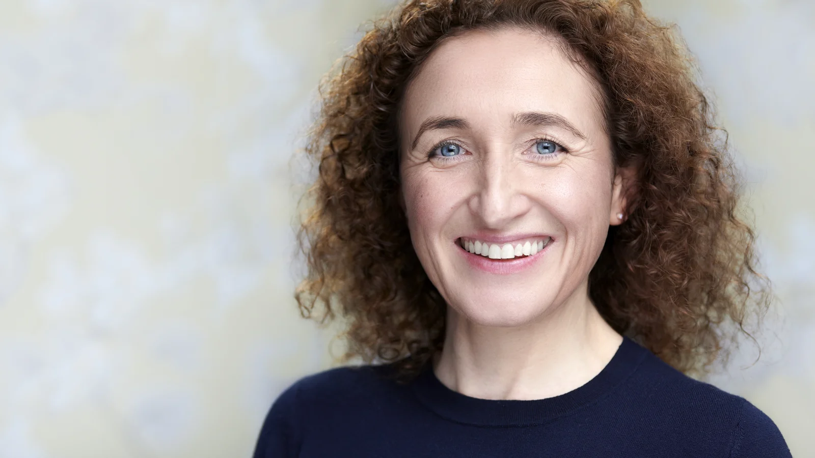 Lizzie Butler personal branding headshot, warm smile against a neutral background