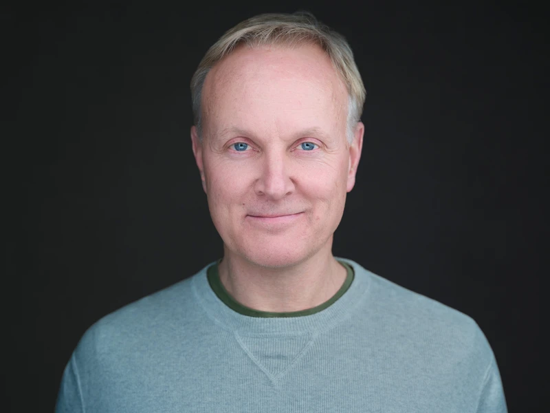 Toast team member corporate headshot, natural expression and modern studio style
