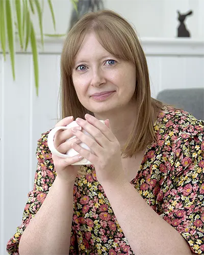 Professional business portrait of a woman designer holding a mug of coffee