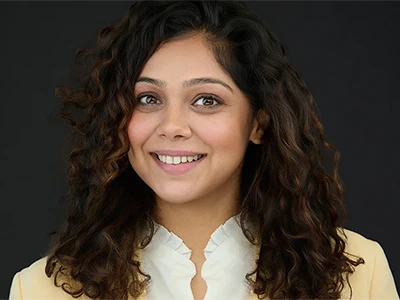 A woman in a blazer and blouse, composed studio portrait with expert lighting