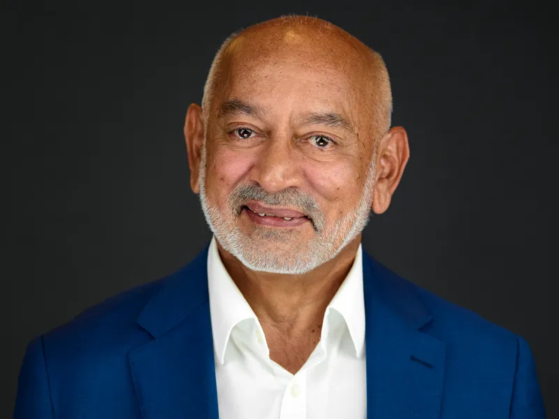 Bearded man in a white dress shirt and blazer, crisp professional headshot with a natural expression