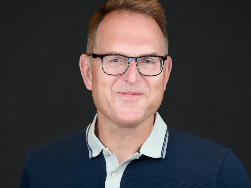 Man in glasses wearing a polo shirt, approachable and composed portrait