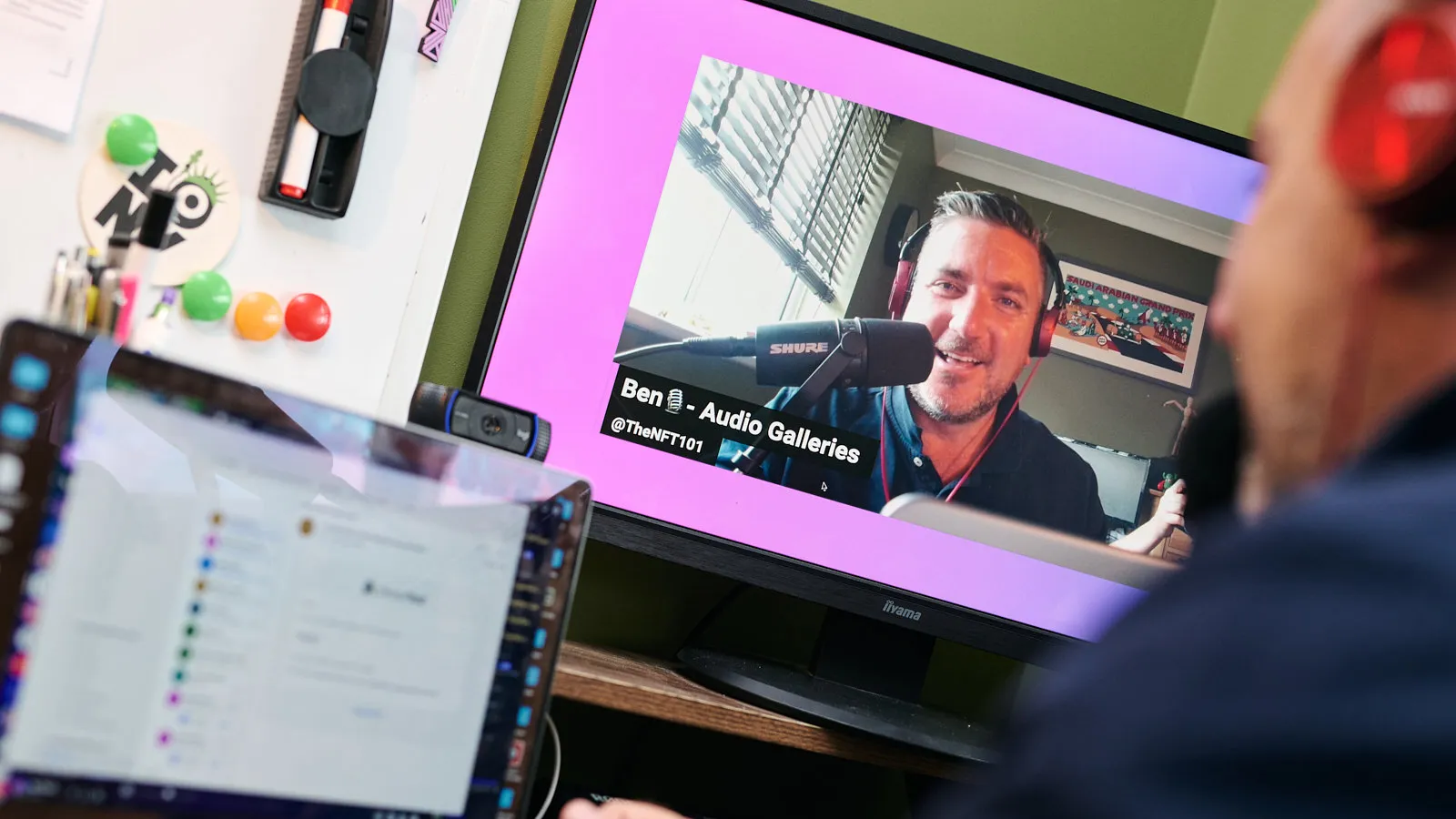 Content creator at a home studio desk recording a podcast